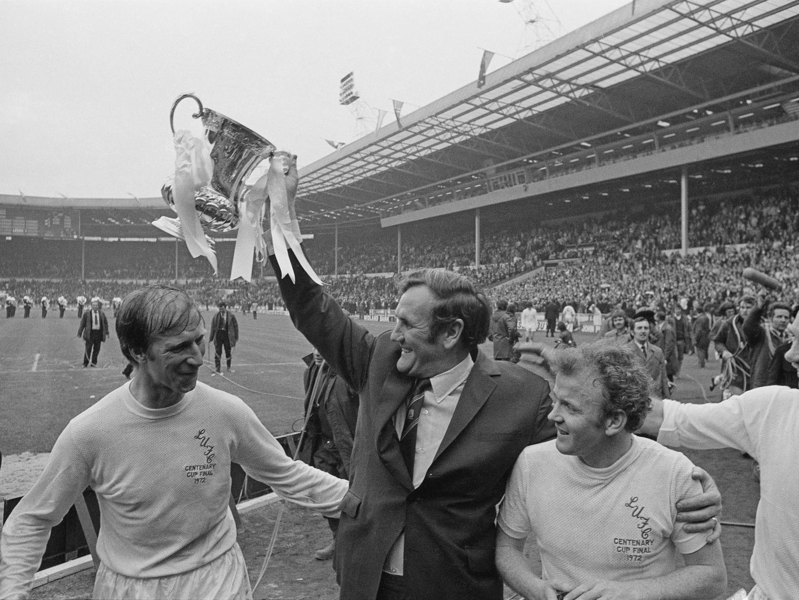 Don Revie lifts the FA Cup after his team beat Arsenal. Also shown are Jack Charlton (left), Billy Bremner, and Paul Reaney (far right).