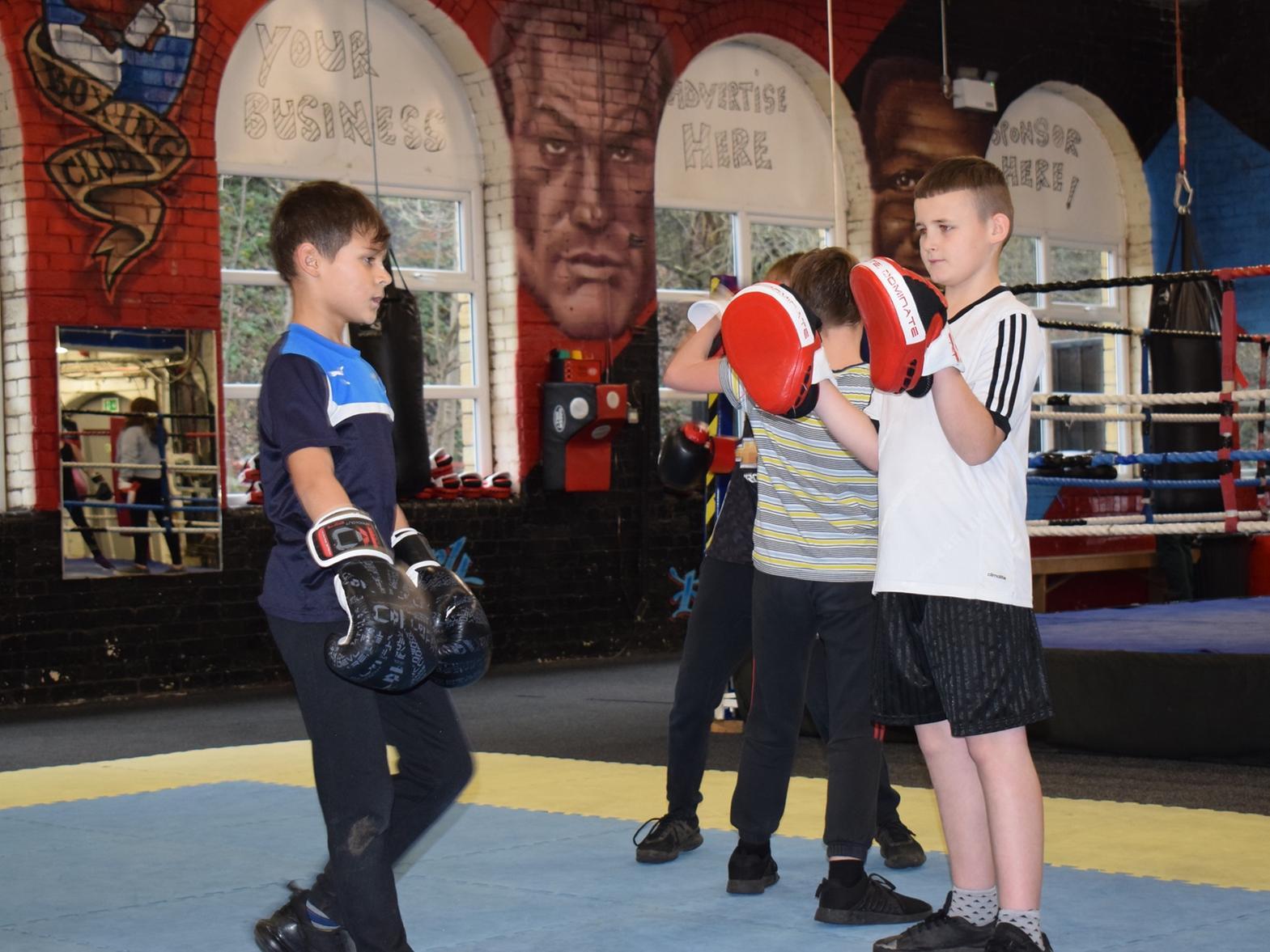 Two young boxers learning combo moves