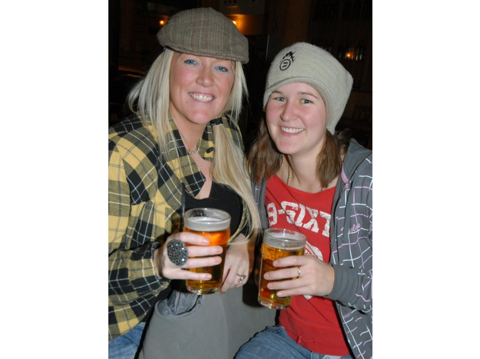 Two girls share a couple of pints.