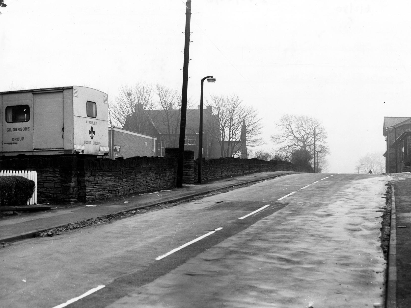 A view looking south along Street Lane. On the left, a van belonging to the 4th Morley/Gildersome Scout Group is parked. Beyond that are Gildersome Liberal Club and St. Peter's Vicarage.