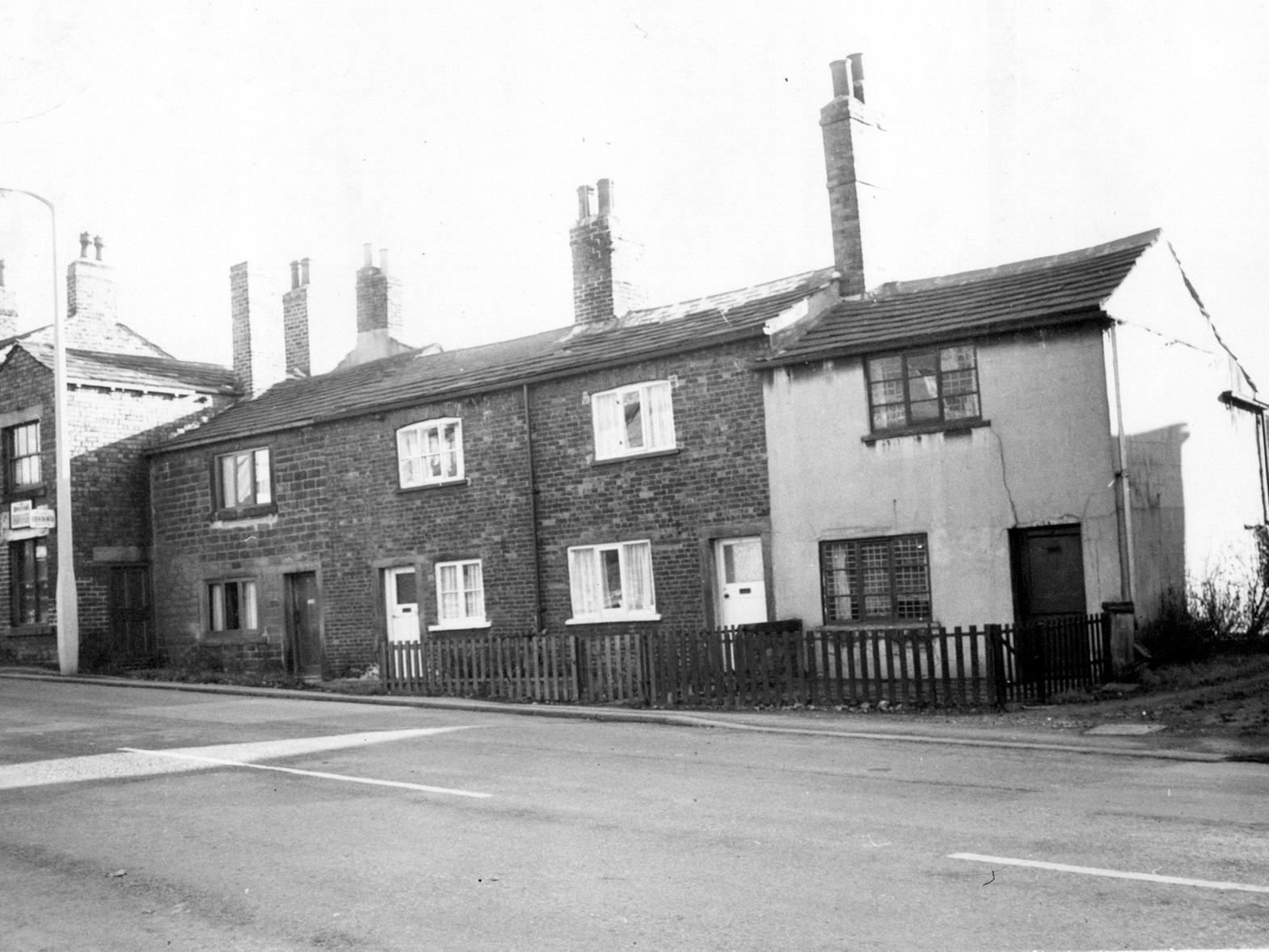 Town Street, Gildersome. Brick built terraced houses with a shop, possibly a cycle repair shop, is to the far left of the photograph.