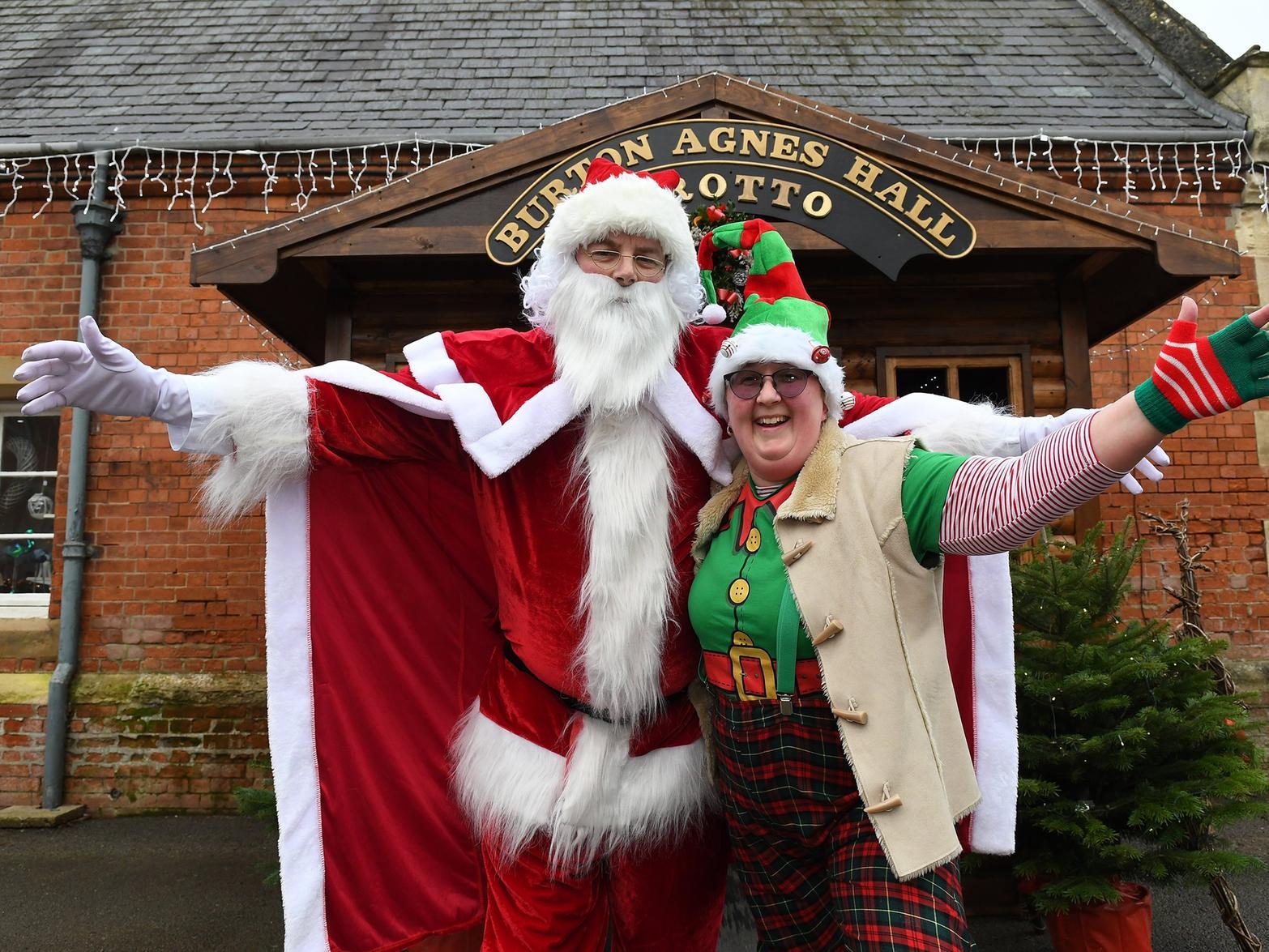 Santa with his helper in the courtyard grotto.