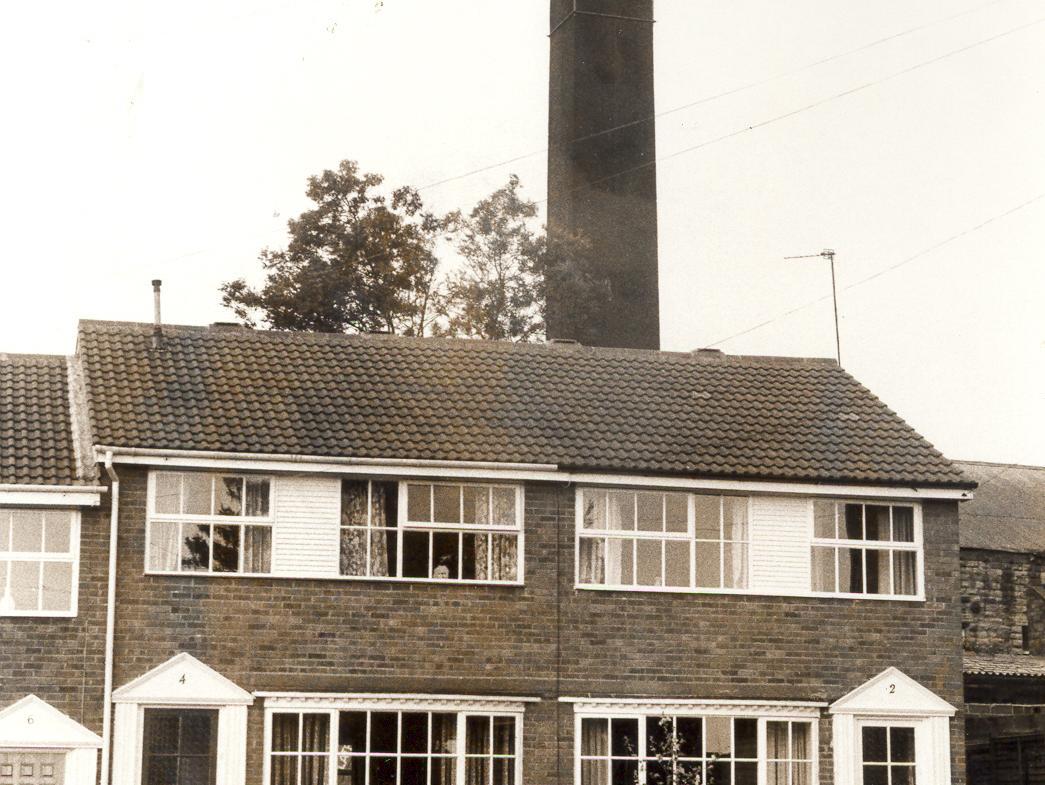 A chimney towering over houses on Bank House Close in Morley.
