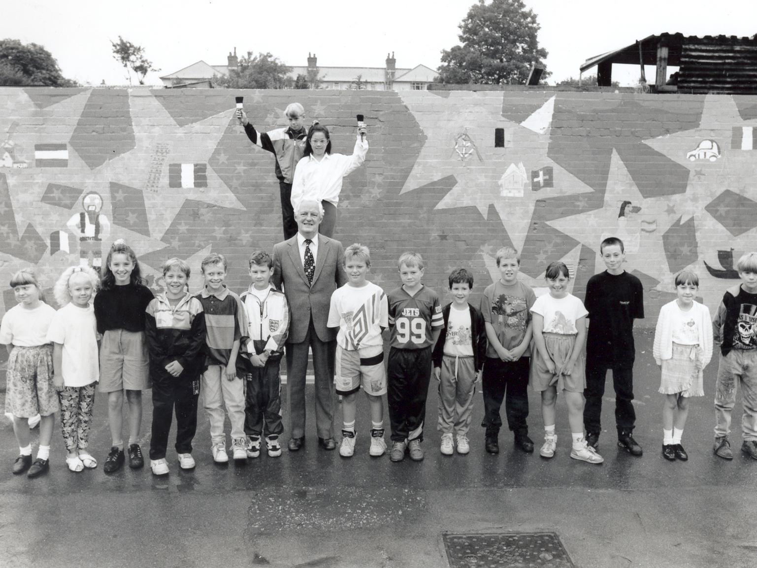 Children at Victoria Junior and Infants School were going continental with this playground mural. Pictured with them is Coun Crotty.