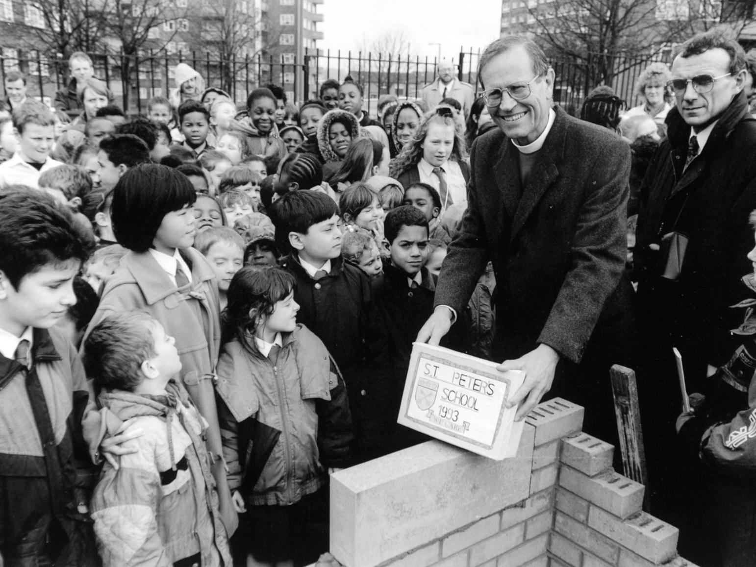 The Bishop of Ripon, the Right Reverend David Young, surrounded by children as he lays a foundation stone at the new St. Peter's C of E School in Burmantofts.