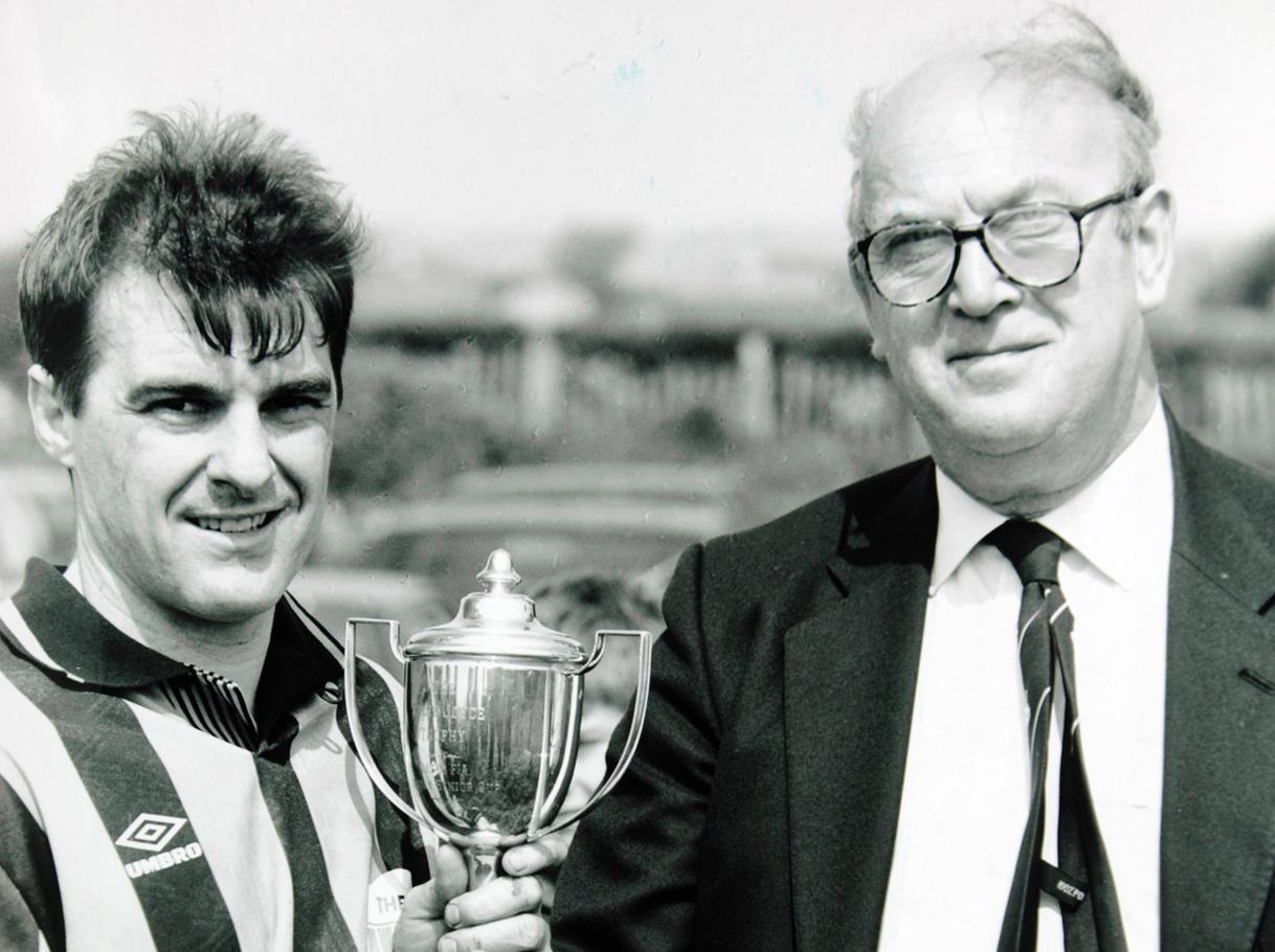 Nigel Jones, of The Gate, receives the Leeds and District Cup from Colin Taylor.
