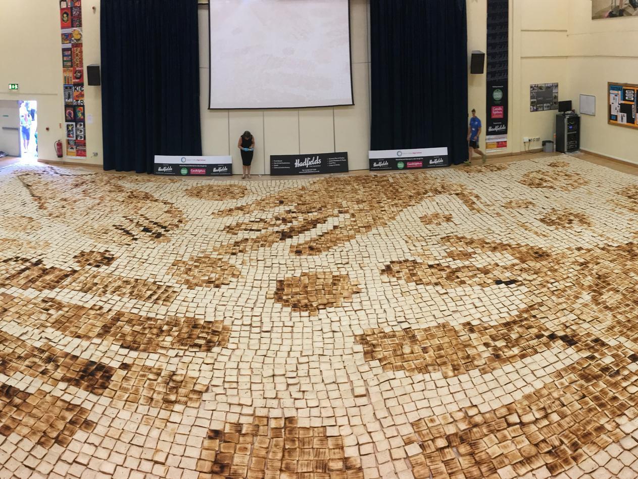 The largest toast mosaic (image) is 189.5 m (2040 ft 105 in) and was achieved by Ryburn School (UK), in Halifax, West Yorkshire, UK, on 13 July 2018.