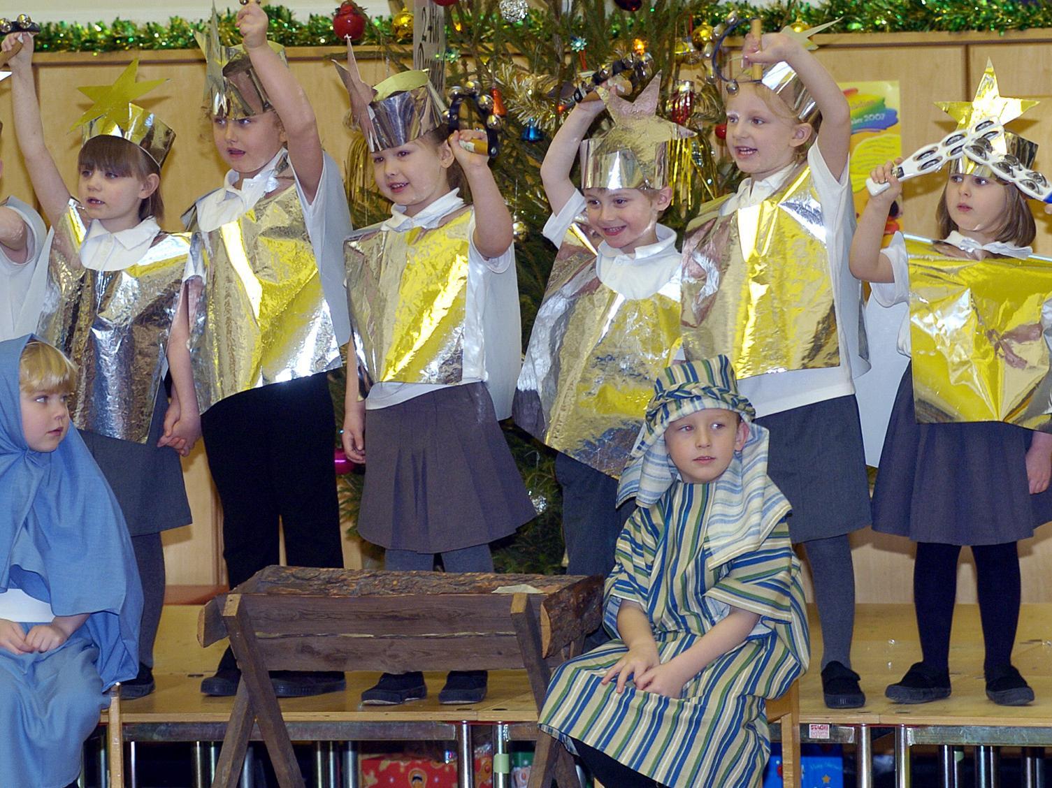 Mary and Joseph backed by singing stars.