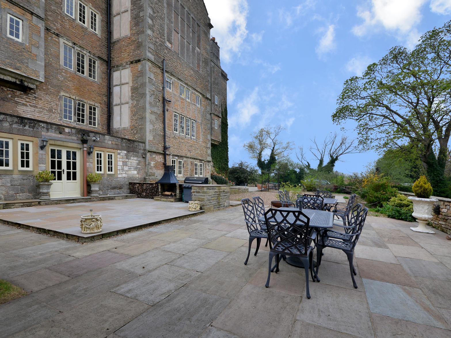 At the rear of the main house is a large patio area that could be perfect for garden parties.