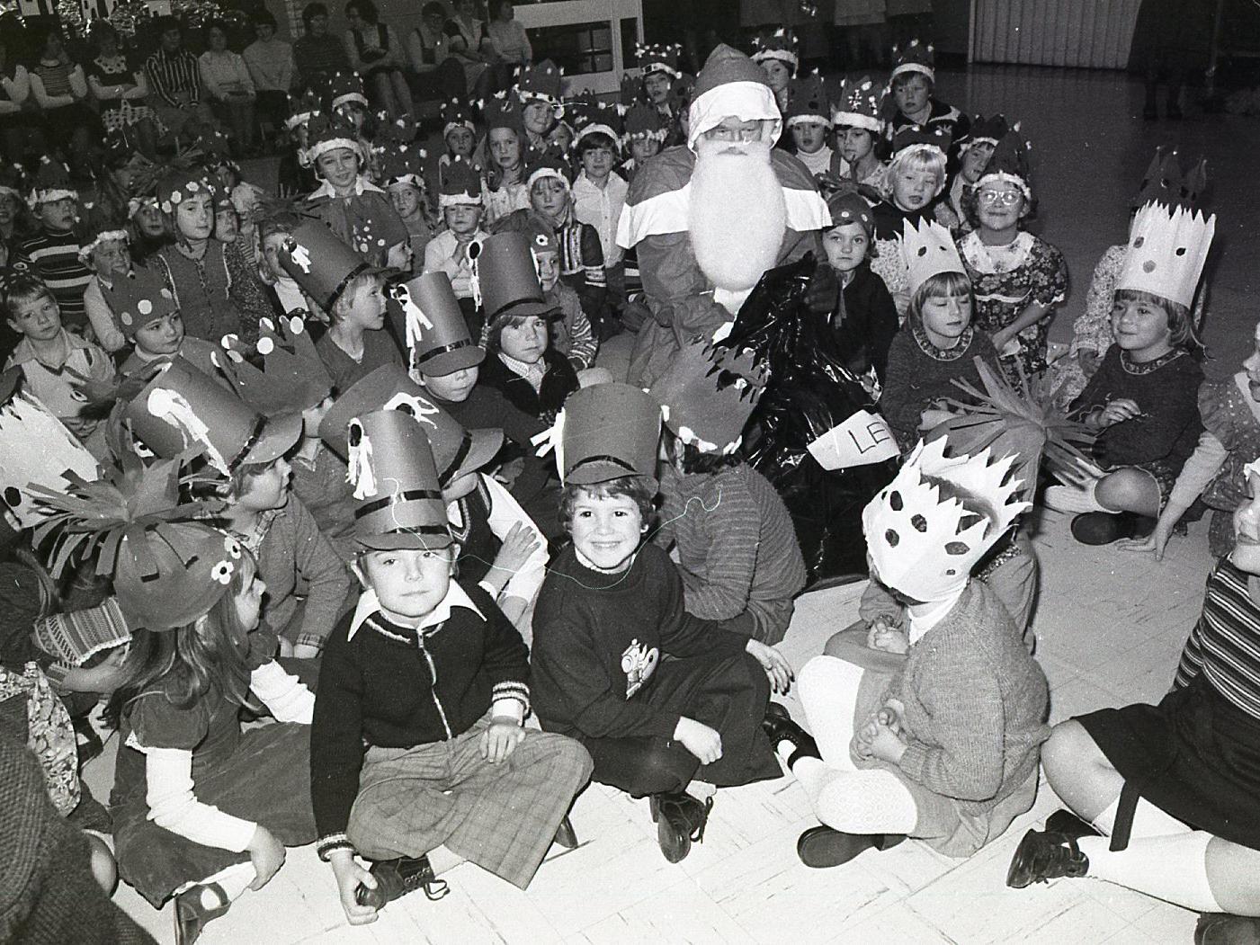 Children at Lever House Primary School, Farington, near Preston, enjoy a visit from Father Christmas during their Christmas party