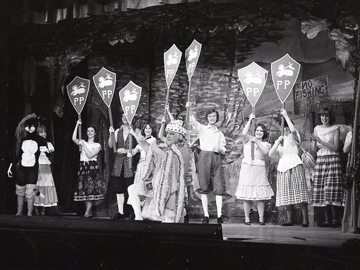 Des Critchley as the King sings "Proud Preston" - backed by a gallery of appropriate shields during a performance of Puss in Boots, presented at Preston Drama Club at Preston Playhouse. The traditional pantomime was written by local actor Nicholas Tomlinson