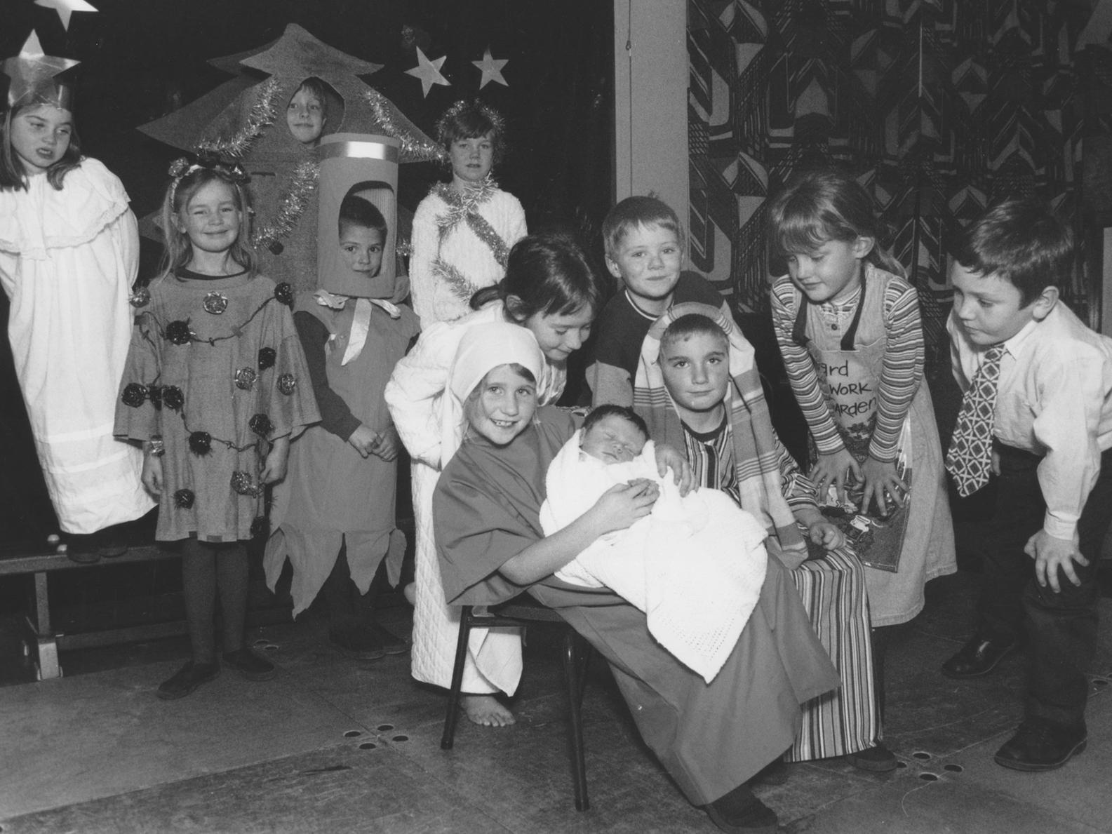 Here are the principal players from St Martin's School Nativity, who used a real baby for the part of Jesus in December 1997. Looking on are, back left to right, Hanna Neil, Tilly Smith, Peter Cowper, Philip Gilbank and Amy Wadsworth; middle row, Alice Hamp, Matthew Shimmin, Georgie Adams and Christopher Woodhouse; front, Holli-Marie Goodlad as Mary, her brother Benjamin Goodlad as baby Jesus, and Luke Emmerson who played Joseph.