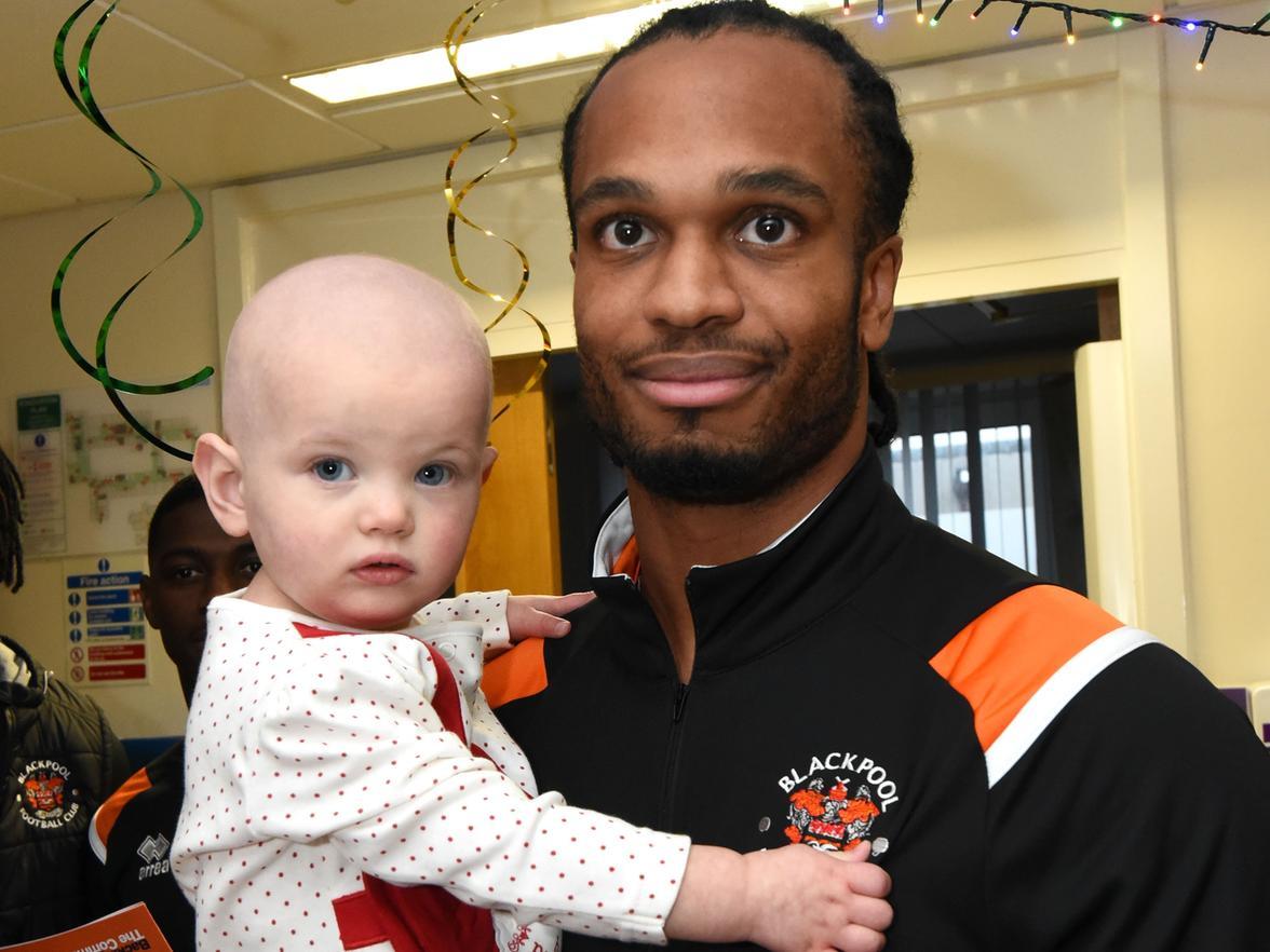 Nathan Delfouneso with 1-year-old Elsie Mottram.