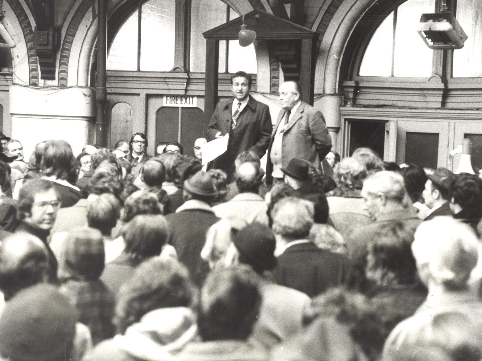 Coun Irwin Bellow, leader of Leeds City Council, and Coun Hudson talk to Kirkgate market traders at a meeting in Leeds Corn Exchange.