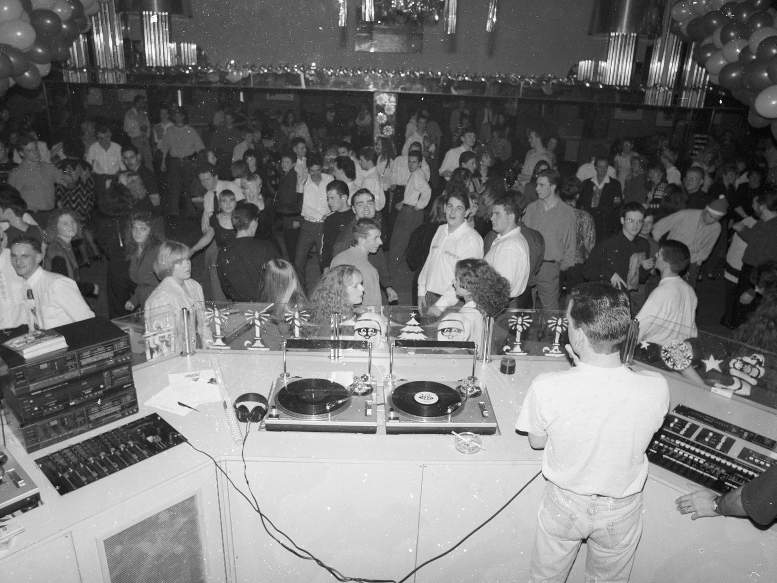 Some revellers have a shirt and tie on and even a Santa hat. But which nightclub was this photo taken in?