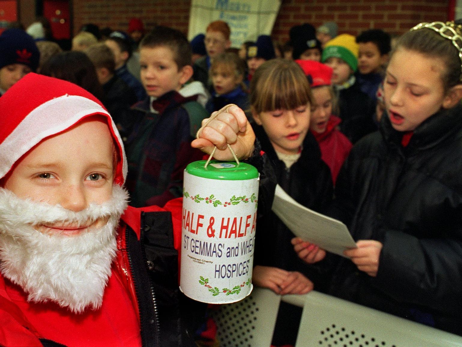 Mini Santa George Brookes and  other children from Mount St. Mary's Primary School sang carols at Leeds Bus Station in aid of Half and Half.