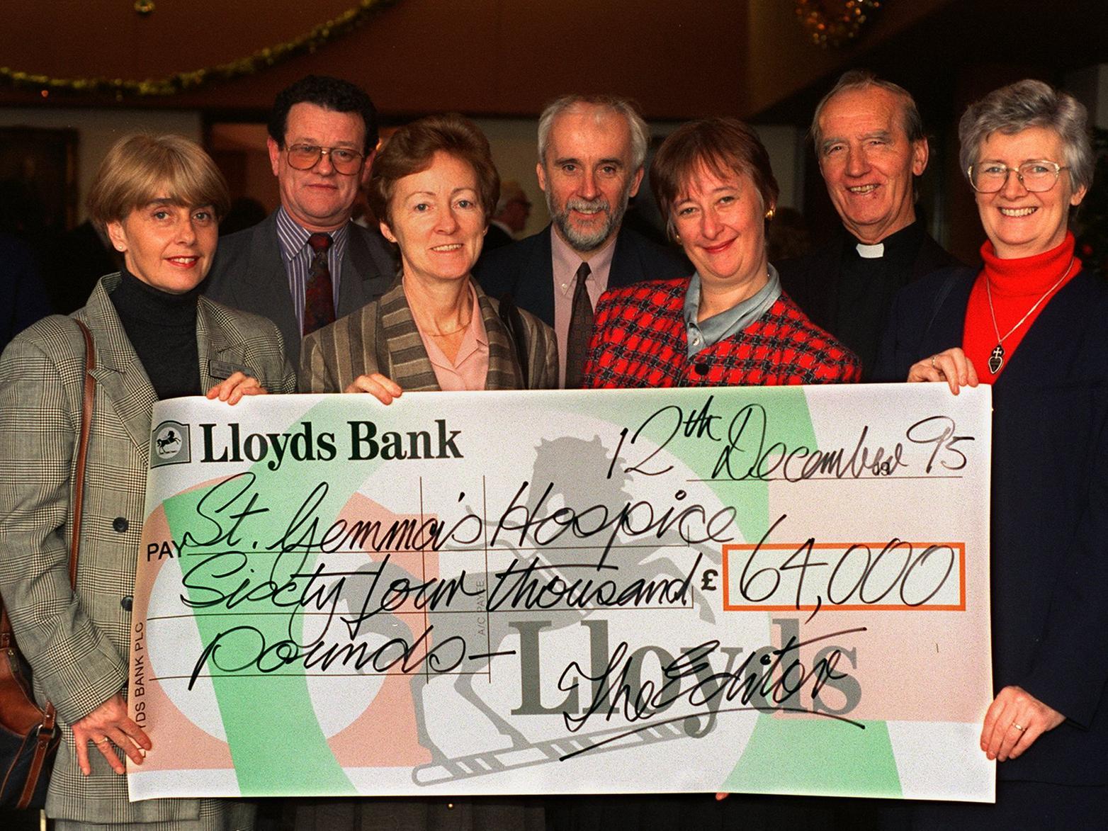 St. Gemma's Hospice staff receive a cheque donated by YEP readers from the Half and Half Appeal. Pictured, left to right, are Pauline Storey, Derek Edwards, Sheila Kelly, Con Egan, Elizabeth Houghton, Father Lyons, and Cecilia Foley.