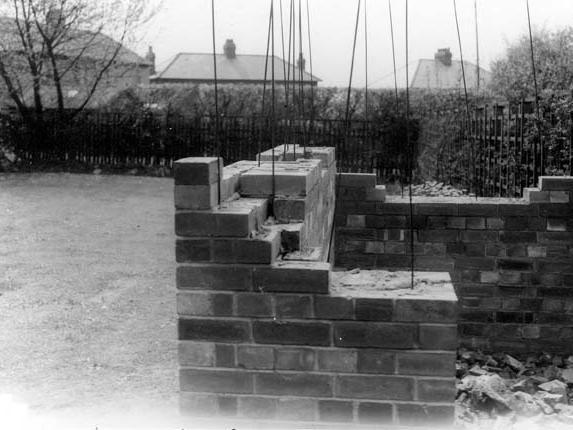 An undated photo of a domestic air raid shelter under construction in a back garden.