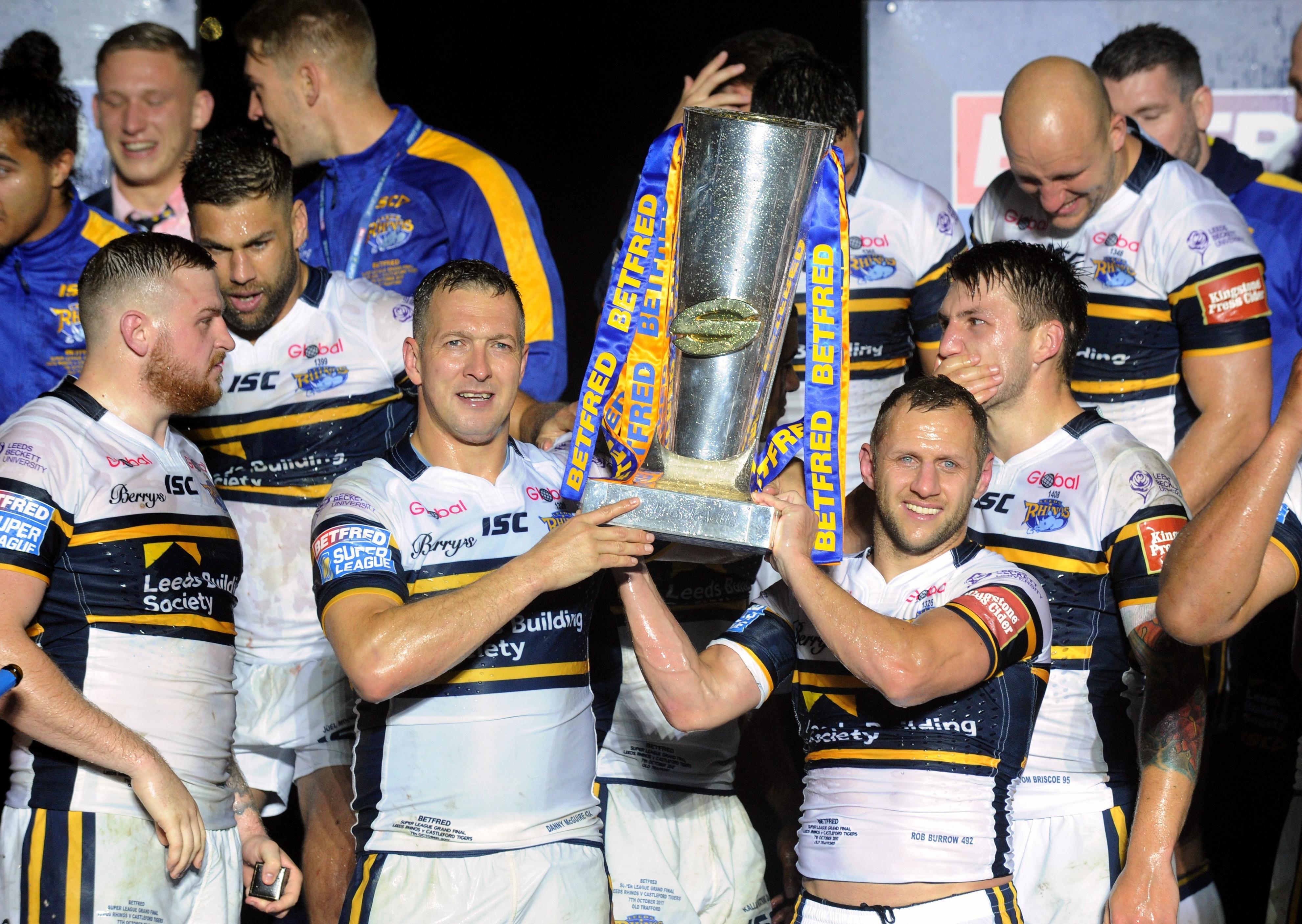 Danny McGuire and Rob Burrow lift the Super League trophy in 2017