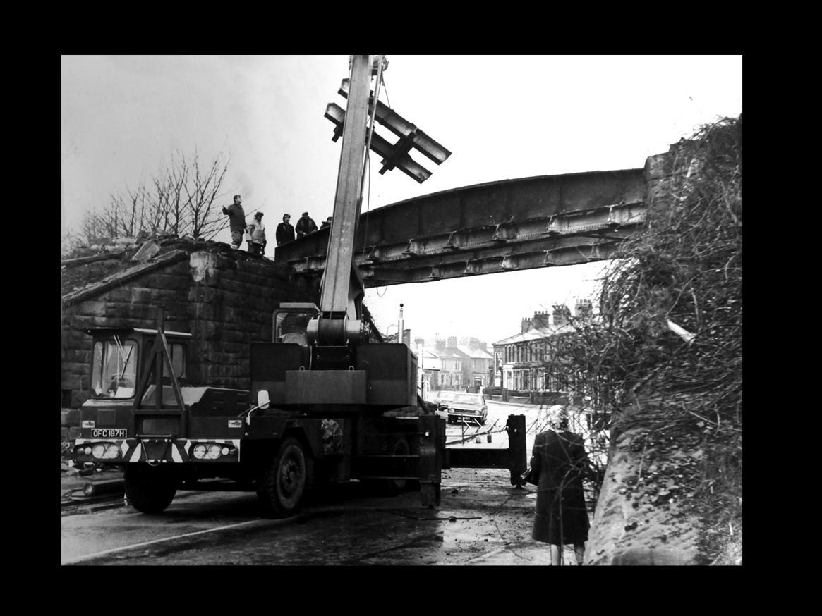 A demolition team get to work on the old railway bridge at Middleforth Green