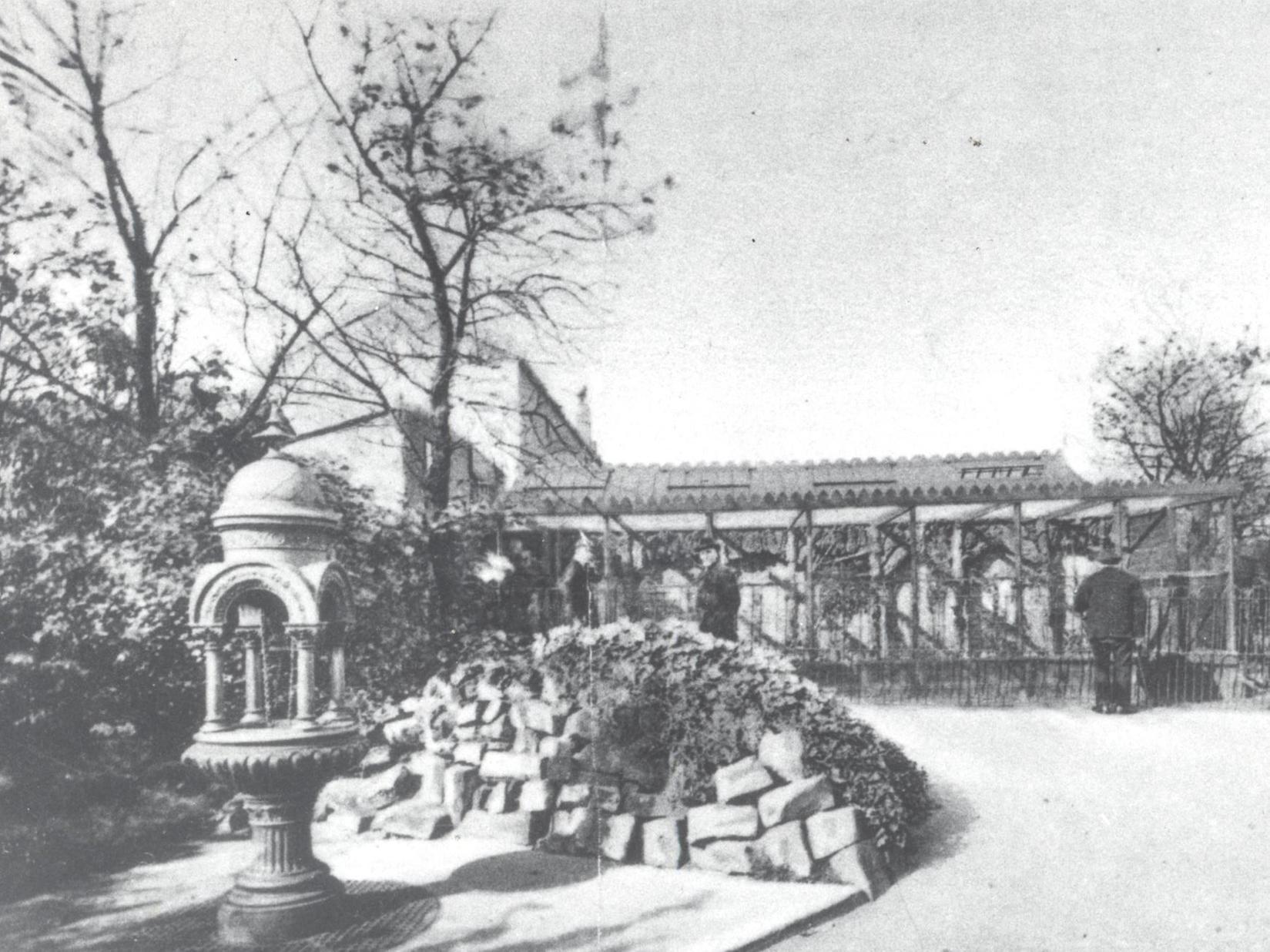 The aviary in Cross Flatts Park in the 1920s. One of the attractions was a talking parrott. On the left is the drinking fountain with its iron cup on a chain.