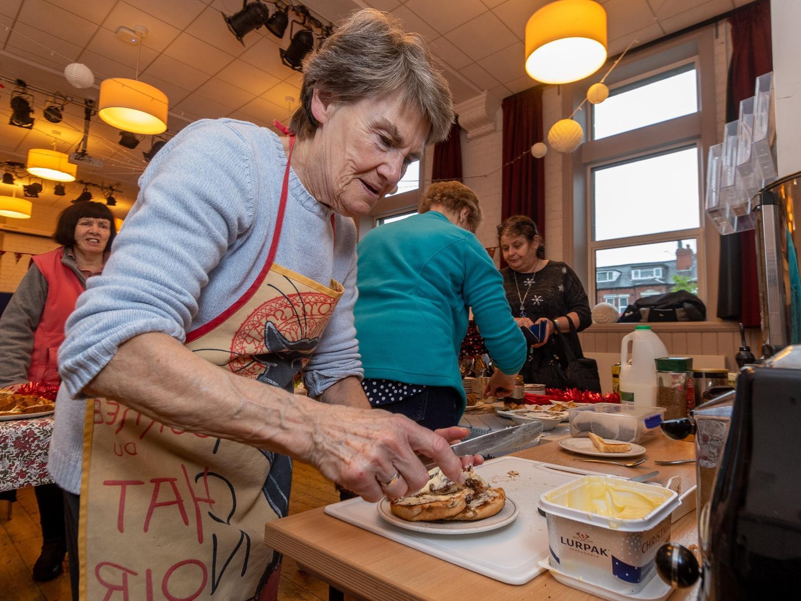 Doreen Cheetham, preparing a snack for a visitor to the morning cafe session.