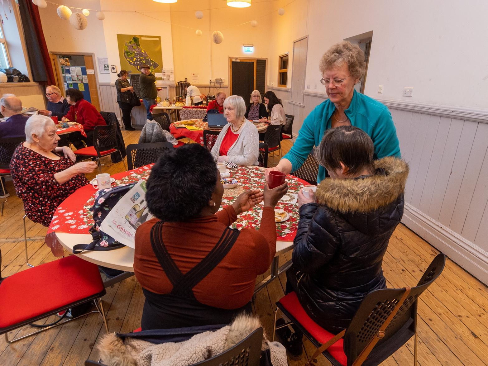 Sonja Buchanan, brings over a cup of tea to a visitor during the morning cafe session.