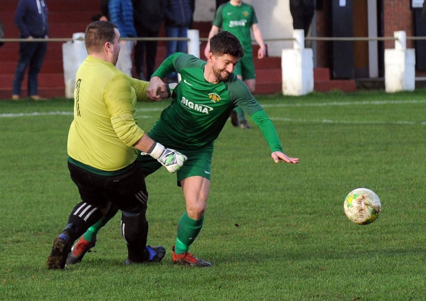 Barrie Frankland of Beeston is fouled by Robin Hood goalkeeper Lee Wood.