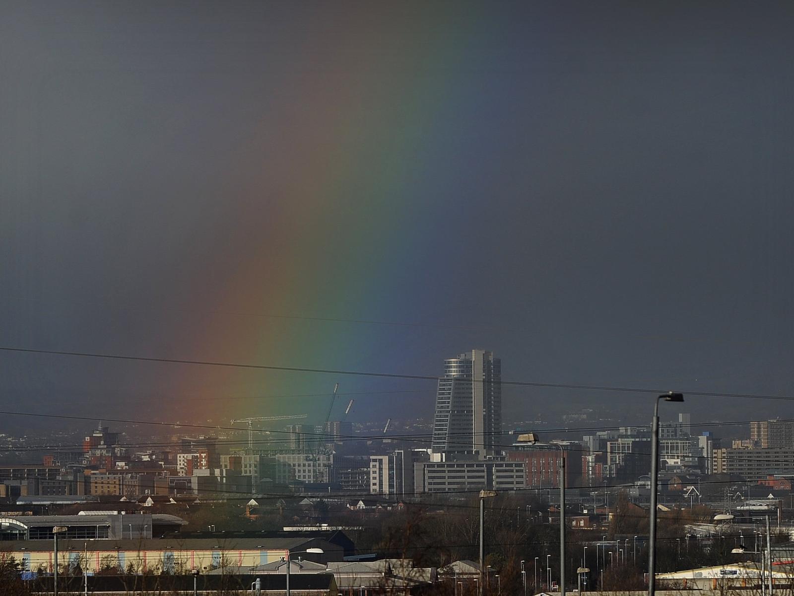 A rainbow forms over Leeds city centre.