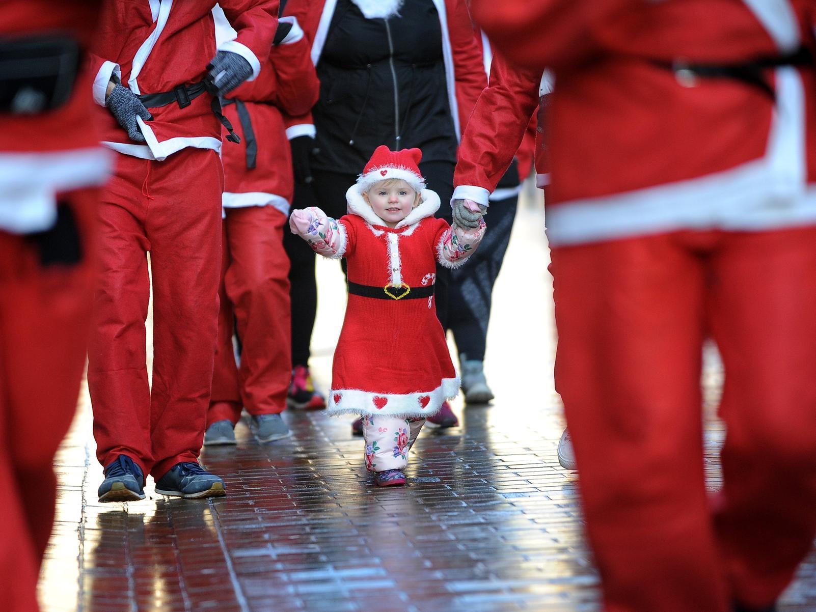 Best foot forward for this young Father Christmas at St Gemma's Santa Dash in Leeds city centre.