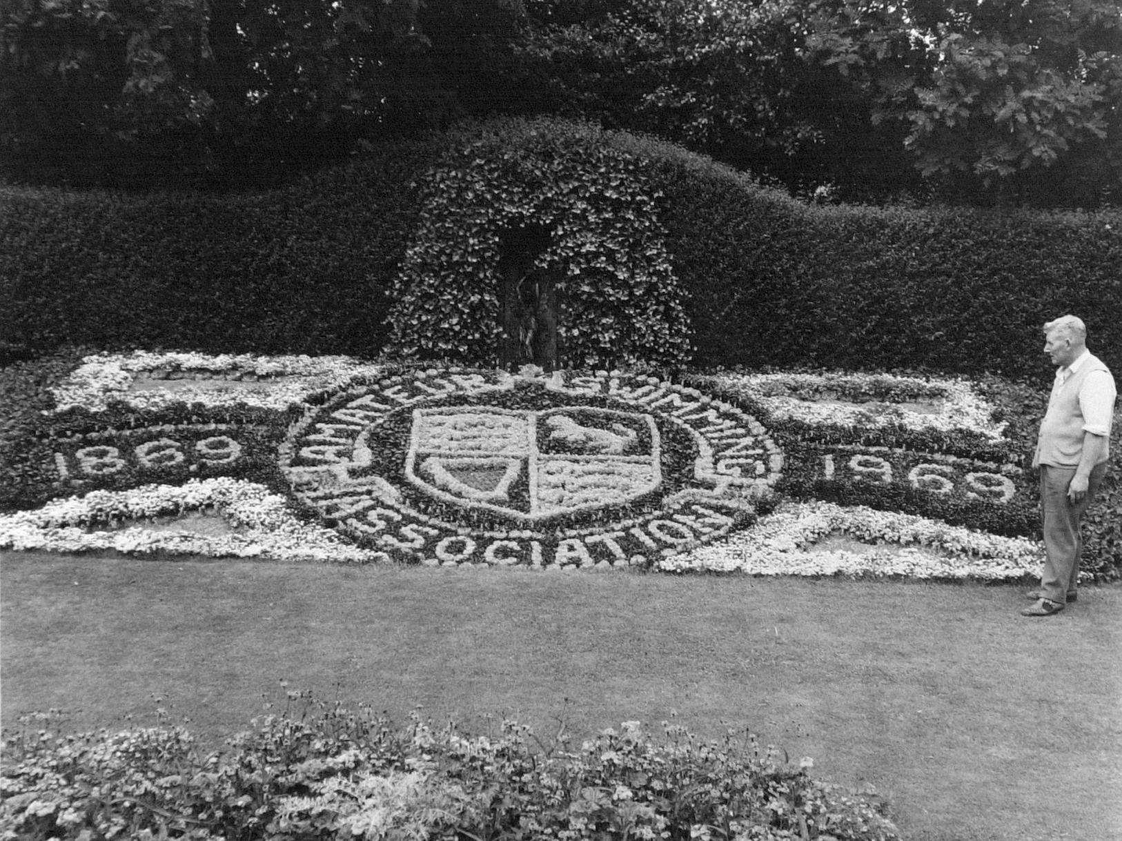 Louis Fett, head gardener at Armley Park, with a floral design he made to commemorate the centenary of the Amateur Swimming Association.