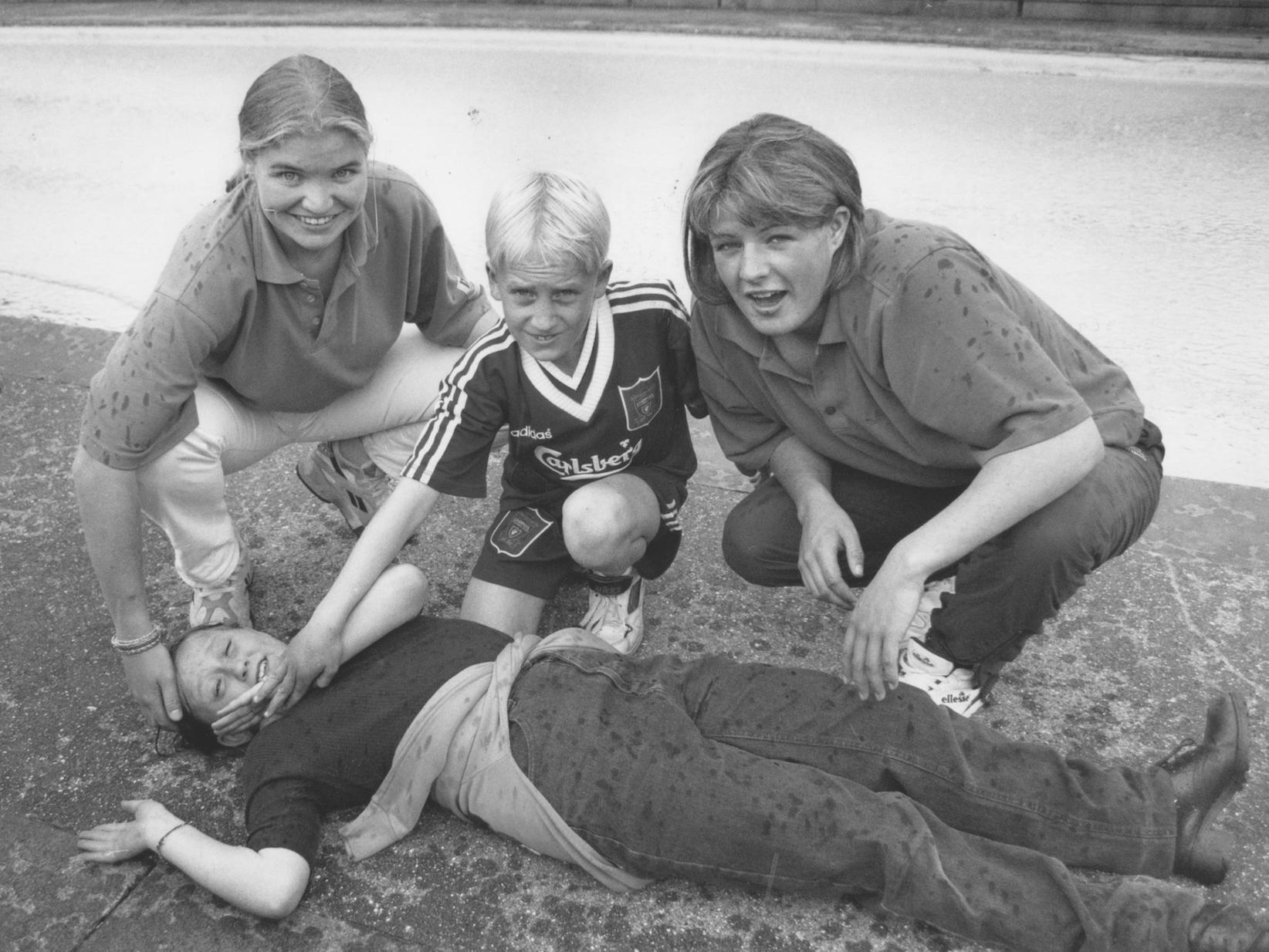 In June 1996 pupils from Hunmanby Primary School were given exercises in emergency first aid. Adele Seamarks and Liz Chapman, left and right, sport science students at Yorkshire Coast College, are pictured instructing Kevin Burton on the recovery position after a possible drowning.