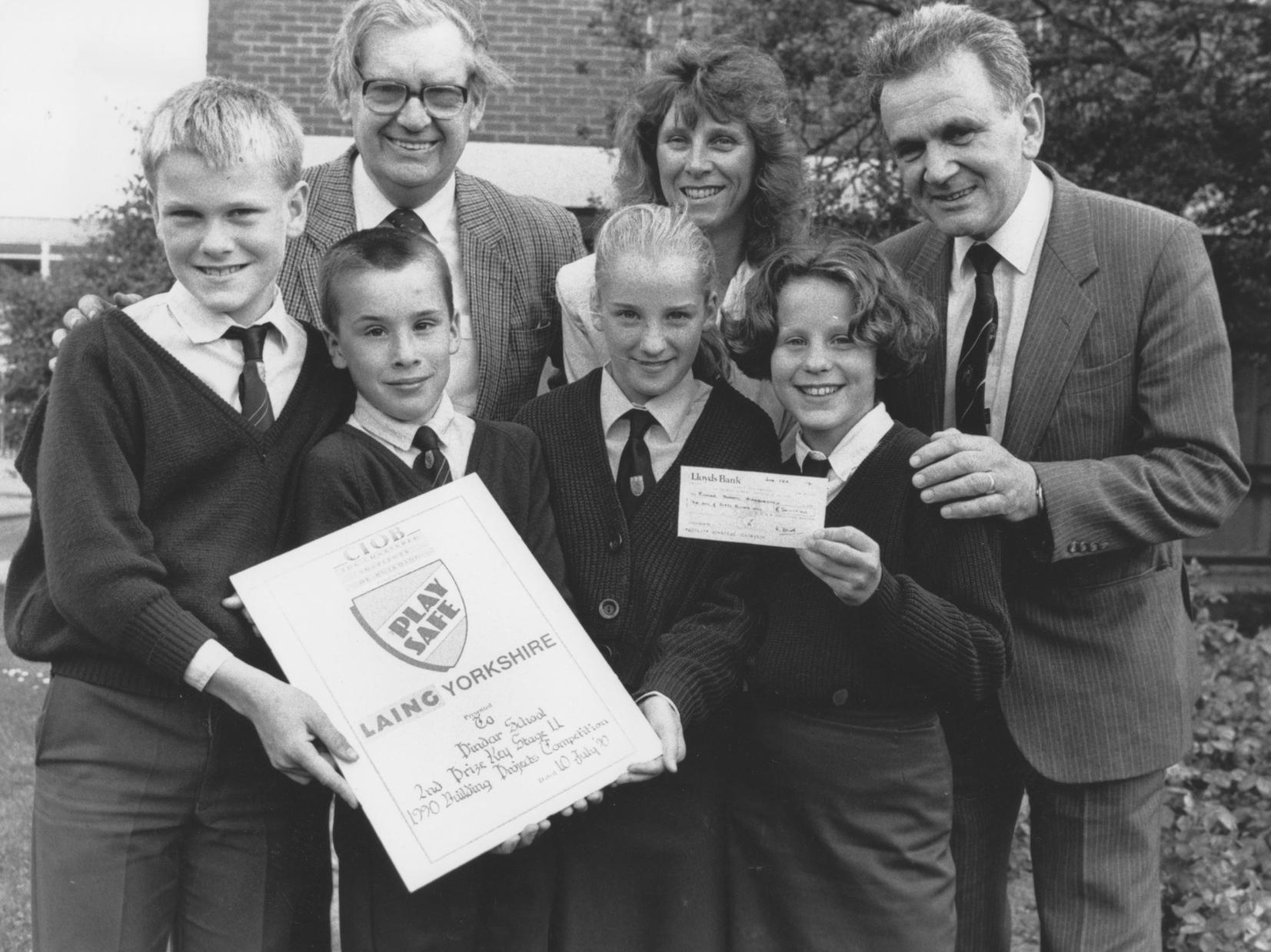 Pindar School came second in a building projects competition in 1990. The award was presented by Jane Preston, back centre, a member of the Construction Industry Training Board, and Bill Bethon, back left, the Regional Executive of the Chartered Institute of Building. They are joined by Cliff Hullah, back right, Head of CDT, and pupils, front, Chris Redford, Richard Evans, Laura Wilson and Rebecca Marsay.