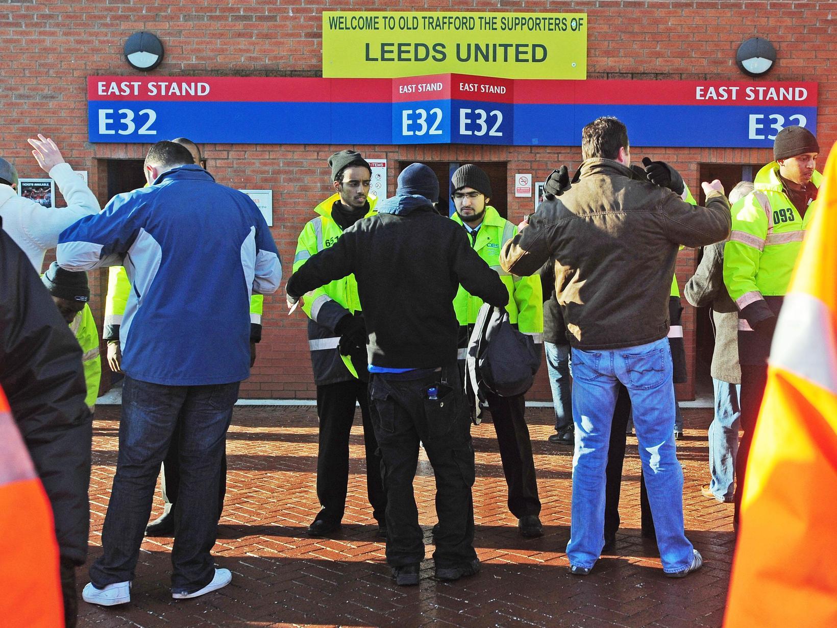 Leeds United fans are searched before entering Old Trafford.