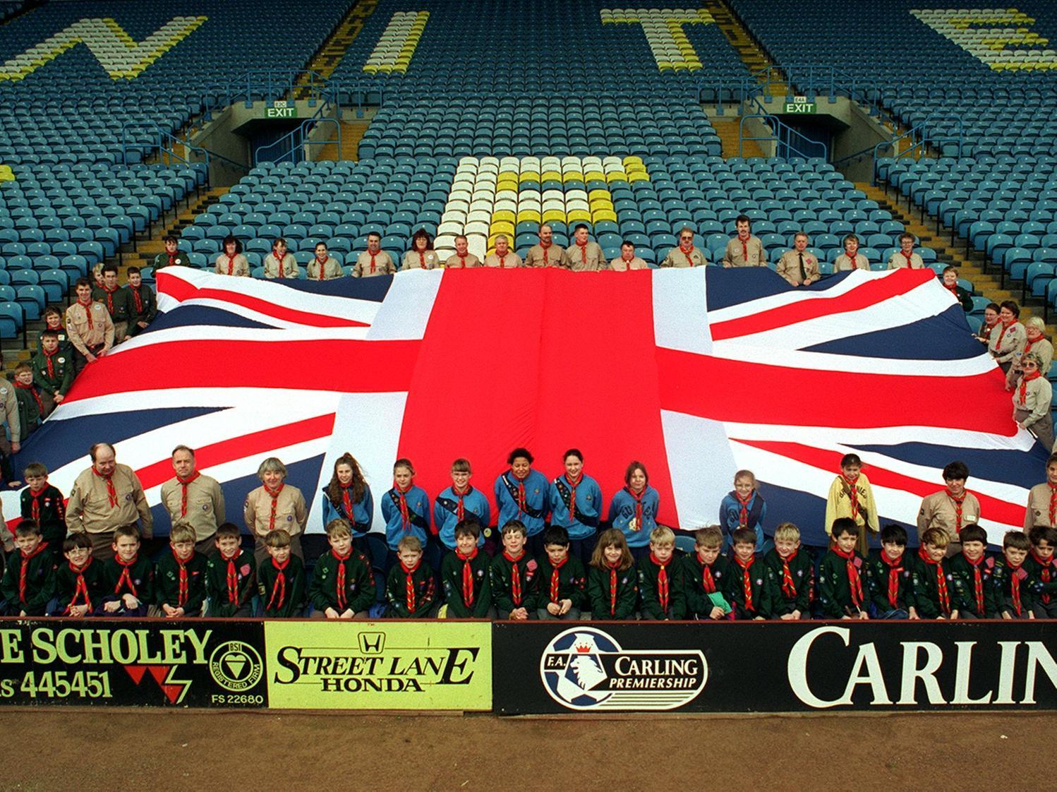 Scouts and leaders representing the 80 strong cast of Central Yorkshire Scouts 1996 Gang Show unite at Elland Road and parade a giant Union Jack flag in February 1996.