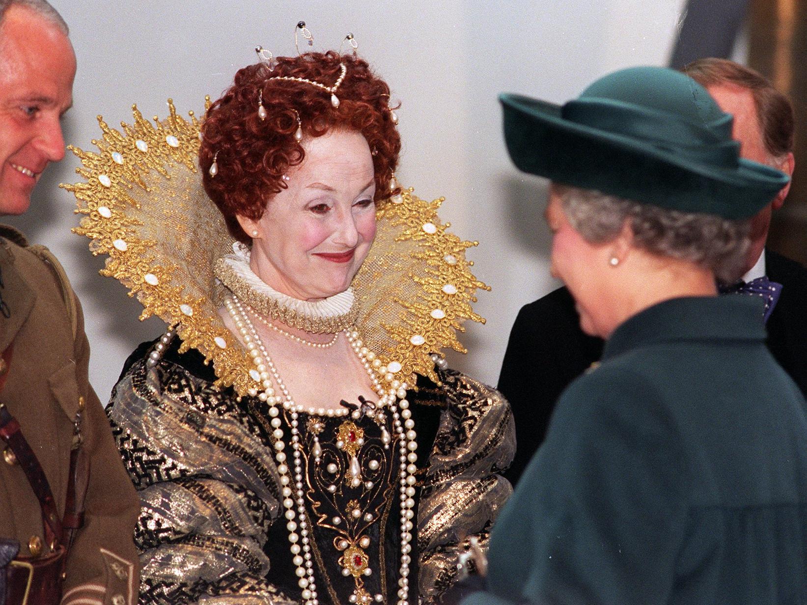 Una Stubbs, in a costume of Queen Elizabeth 1, meets Queen Elizabeth 2 during her visit to Leeds for the opening of The Royal Armouries in March 1996.