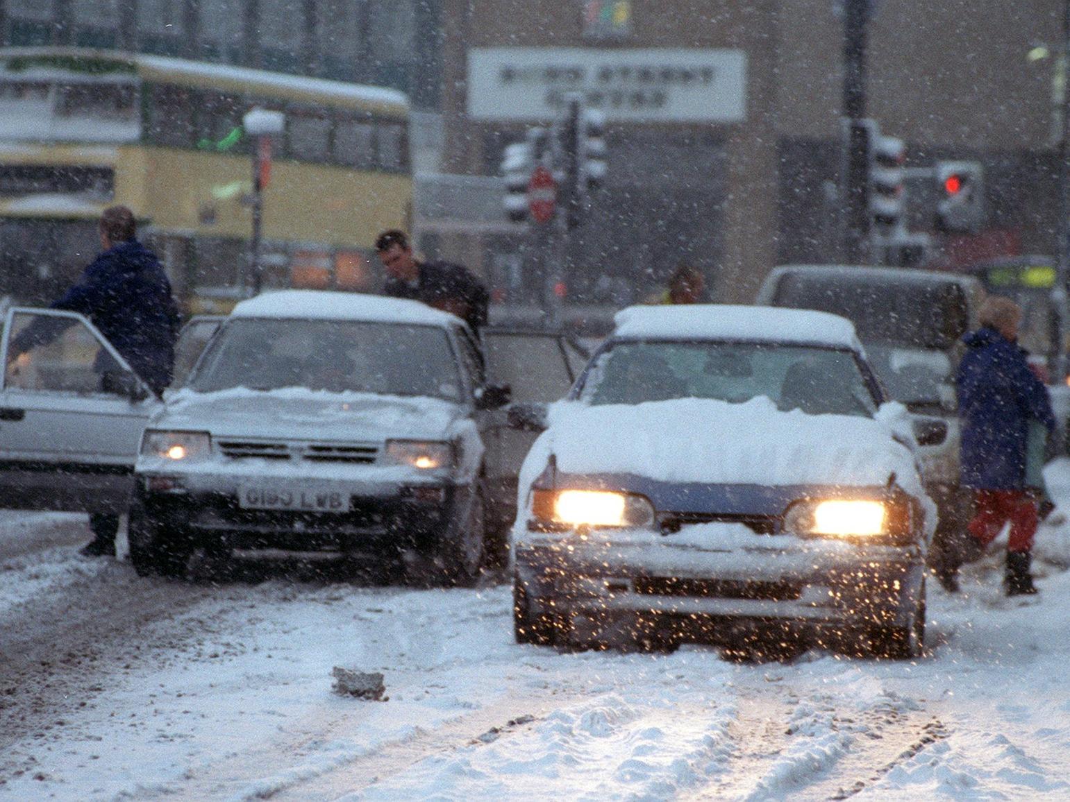 Motorists struggle in the snow at City Square.