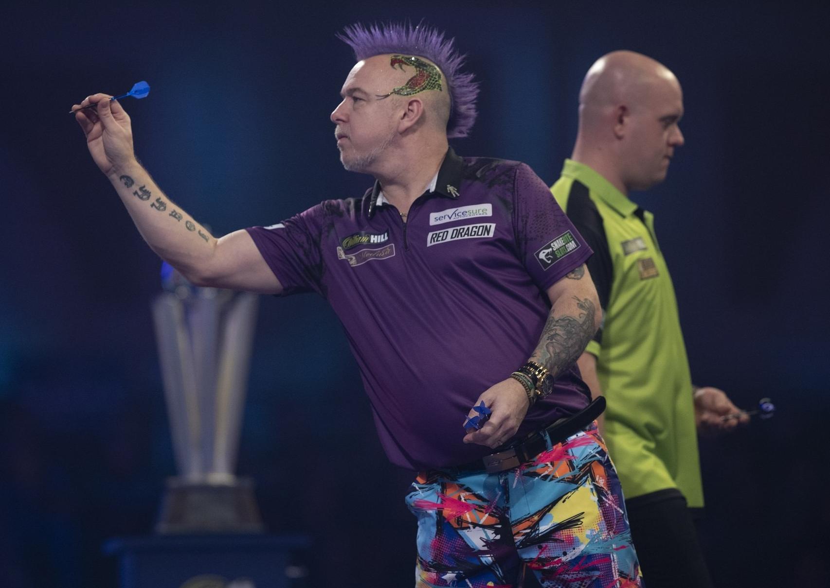 Peter Wright in action against Michael Van Gerwan in the final of the PDC World Darts Championship. Picture: Lawrence Lustig.