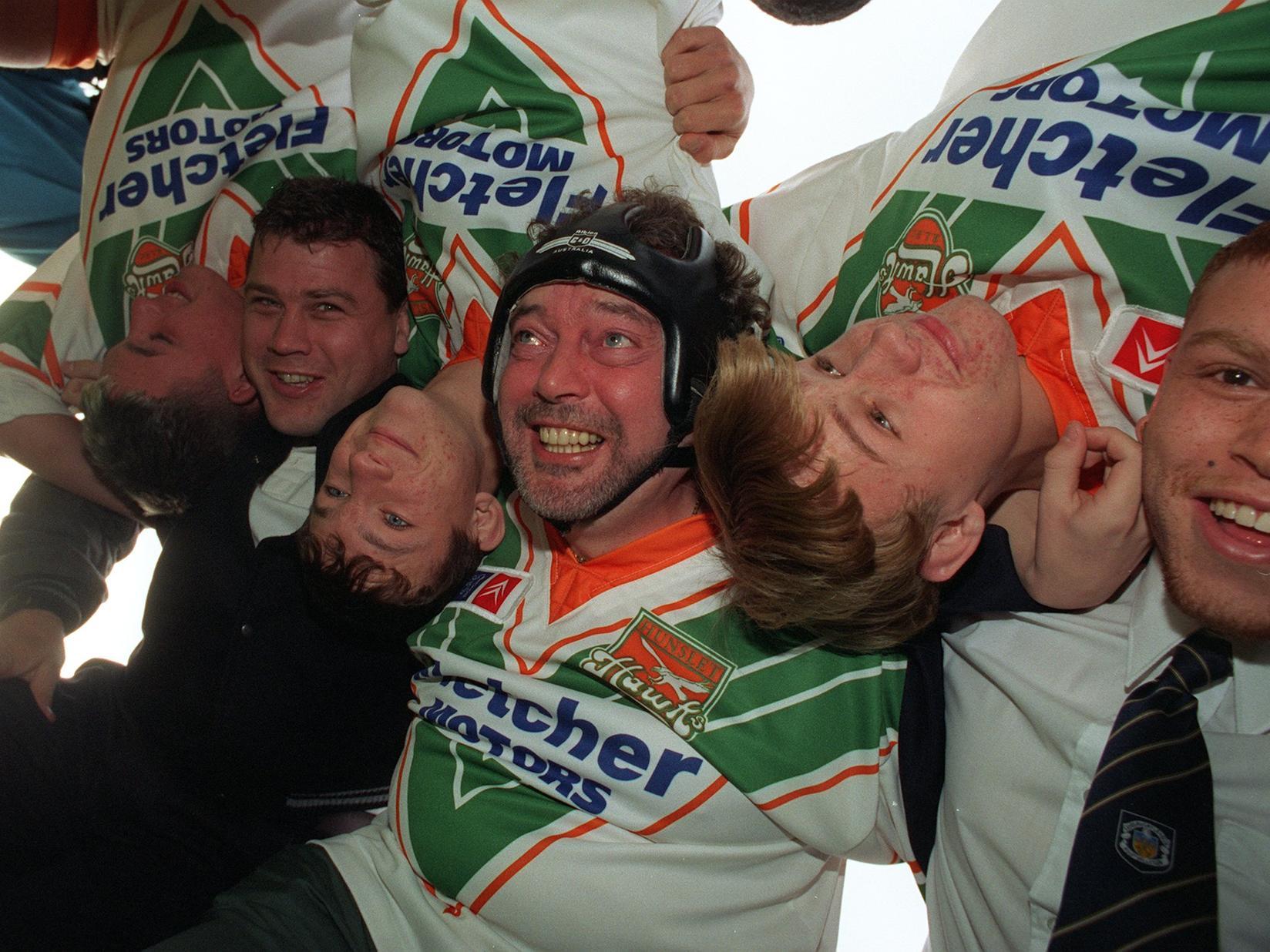 TV prankster Jeremy Beadle finds life tough in the scrum with some of the youngsters from Hunslet Parkside (all upside down), James Lowes (left) and Marvin Goulden (right). Pictured in November 1996.