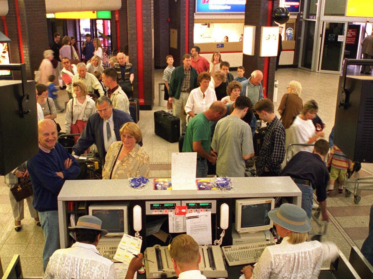 Wish you were here? Holidaymakers check in at Leeds and Bradford Airport in June 1996.