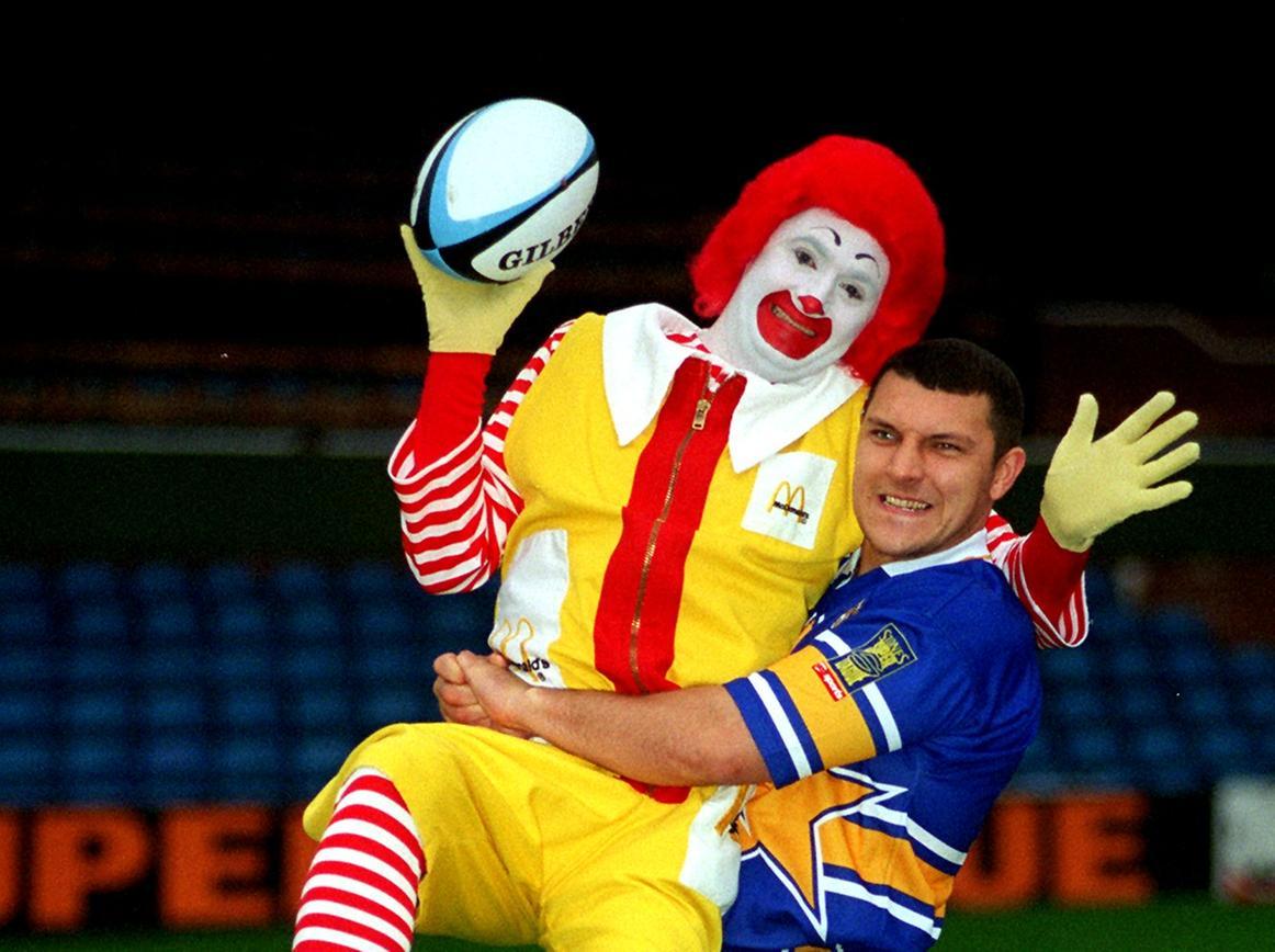 Mac meets Big Mac. Ronald McDonald is lifted off his feet by Barrie Mc Dermott for the launch of the new McDonalds family stand in November 1996.