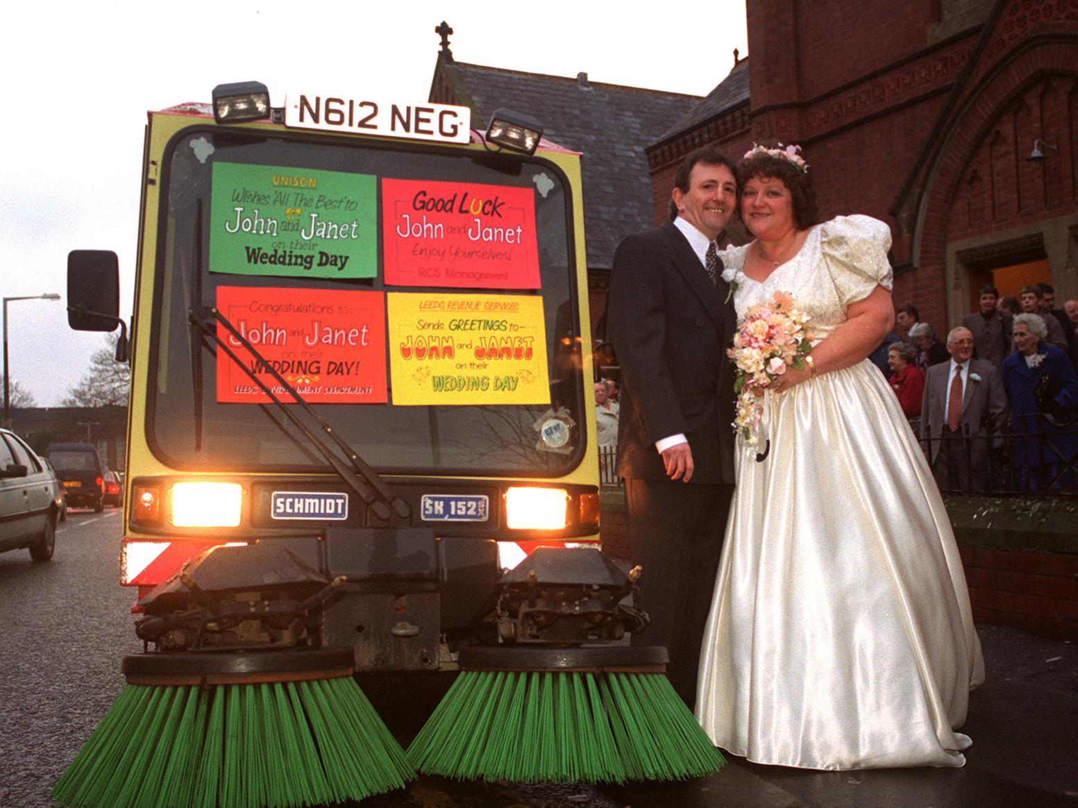John Lince and bride Janet Roberts after their wedding at Crossgates Methodist Church with a street cleaner bearing good luck messages.