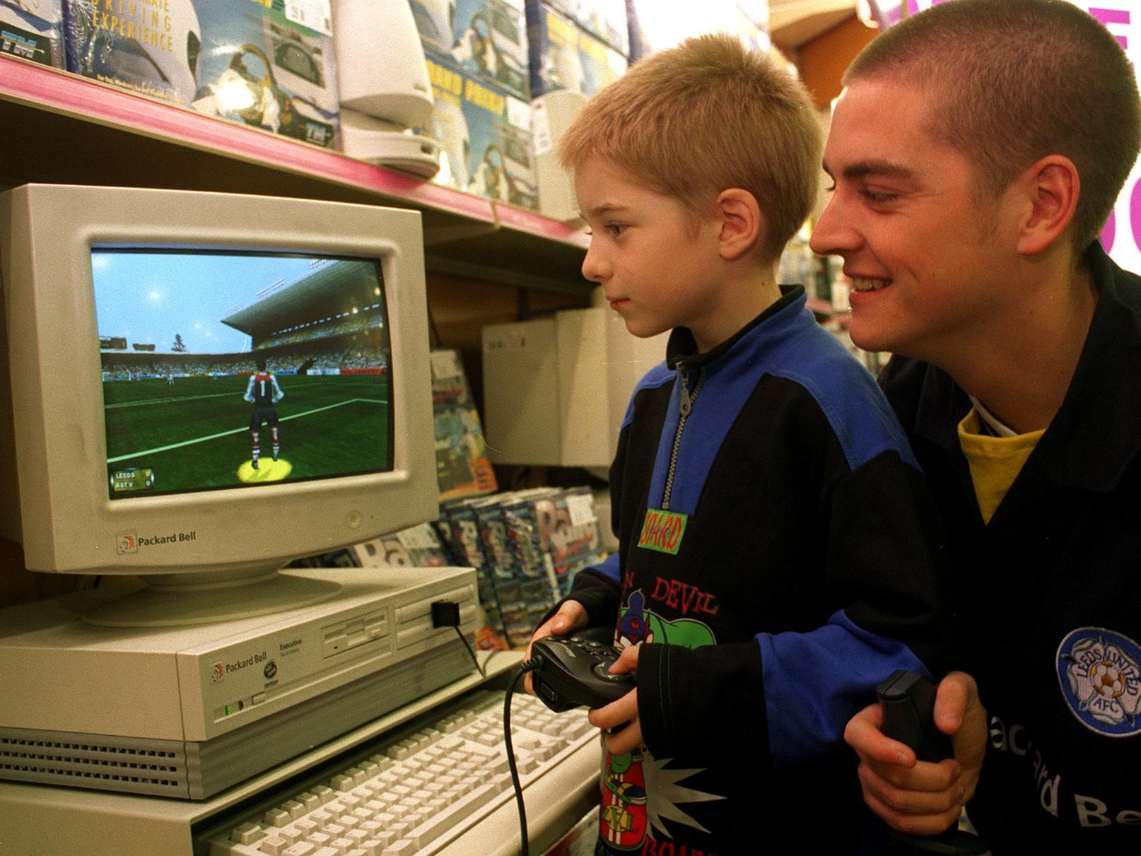 Young James Salt takes on Leeds United's Mark Ford at a game of FIFA97. Fordy and Lee Bowyer were visiting PC World in Beeston. Pictured in December 1996.
