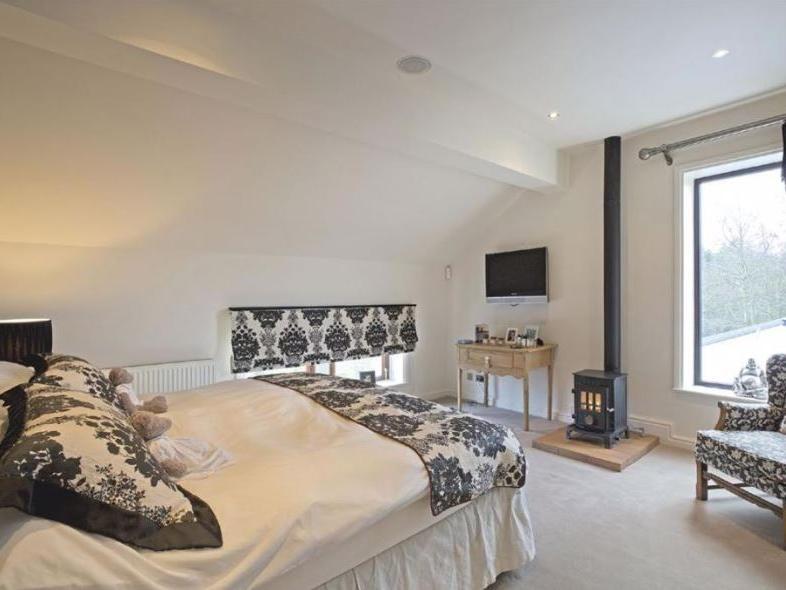 The superb master bedroom encompasses a fitted dressing area and newly installed luxury en-suite bathroom.