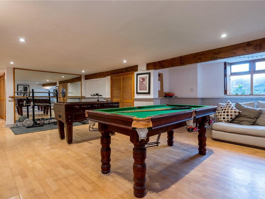 The cellar has been converted to house an excellent games room and gym, as well as a sauna area in need of some renovation and a large home workshop.