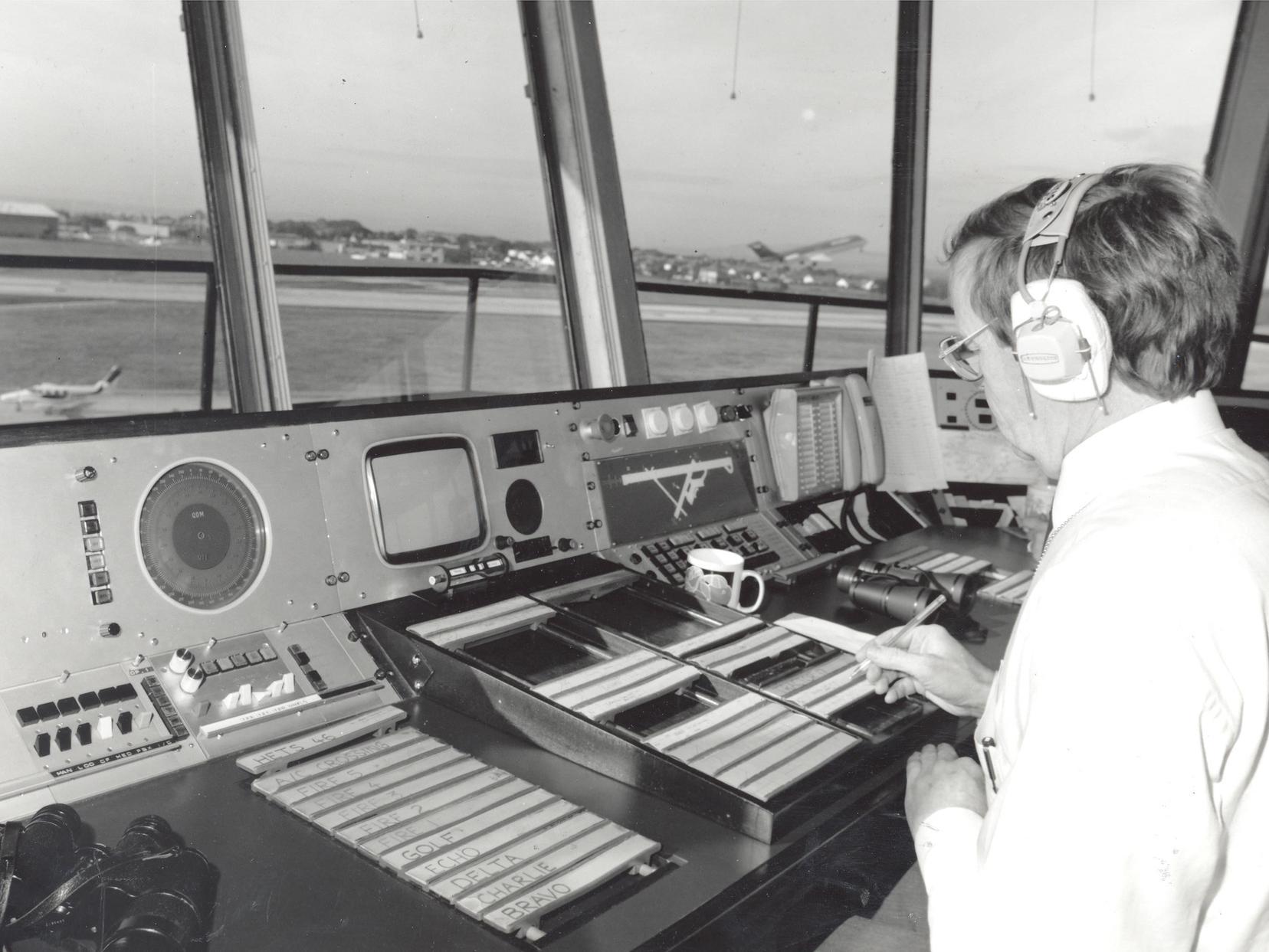 An air traffic controller at work as a plane takes to the air.