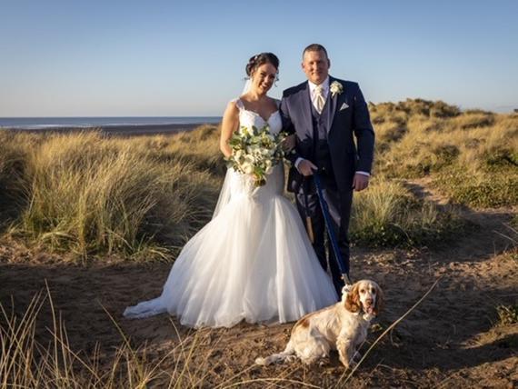 The couples cocker spaniel, Millie, joined them at the dog-friendly venue where she enjoyed all the fuss from friends and family before joining the couple for photos on the sand dunes.