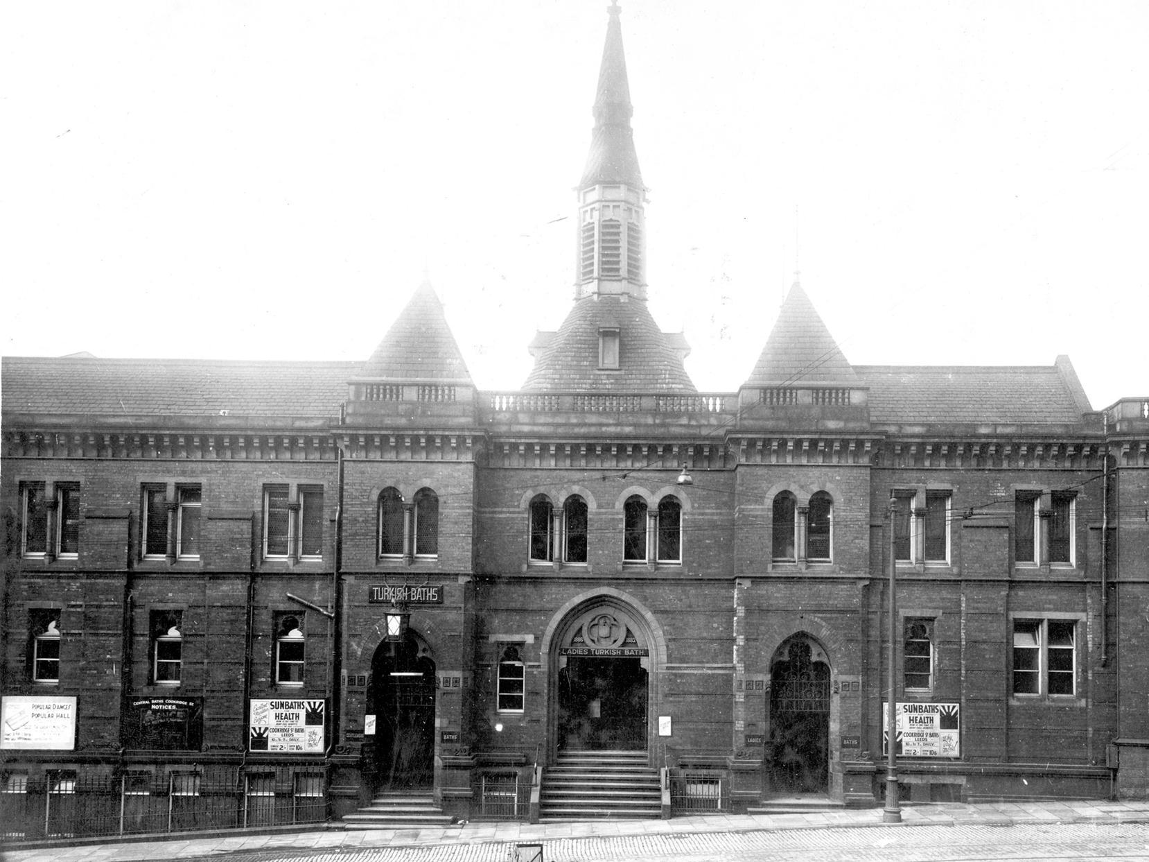 Cookridge Street Baths in Leeds city centre. The site is now part of Millennium Square. This view shows central entrance with notice for 'Ladies Turkish Bath'. Separate entrances for men on the right, and women on the left.