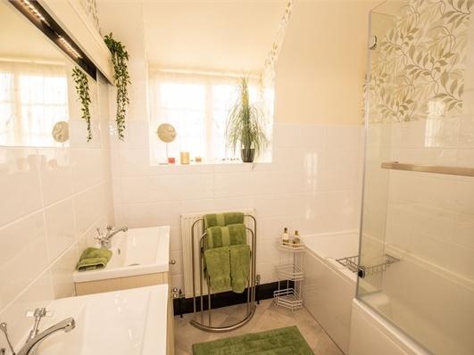 One of the propertys three bathrooms fitted in a modern style.