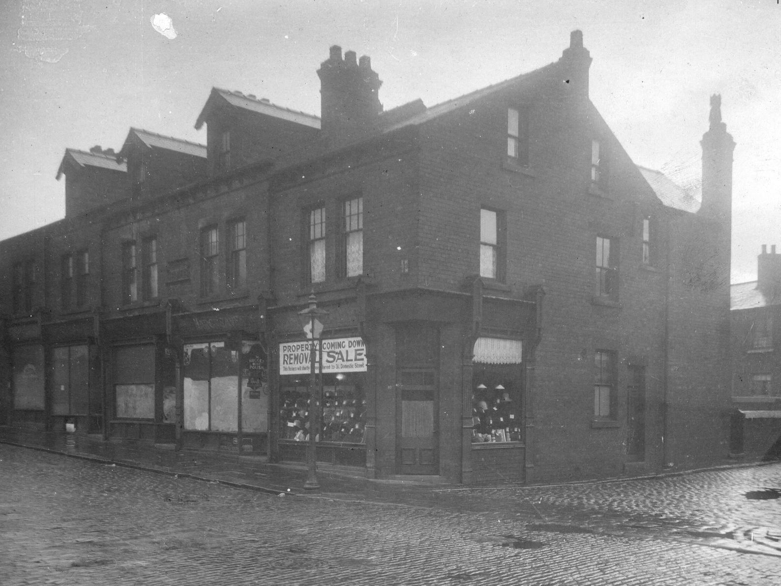 Parade of shops on Domestic Street in Holbeck. To the right is Mann Place and then number 10 Domestic Street is Miss Eliza Eastwood, milliner.
